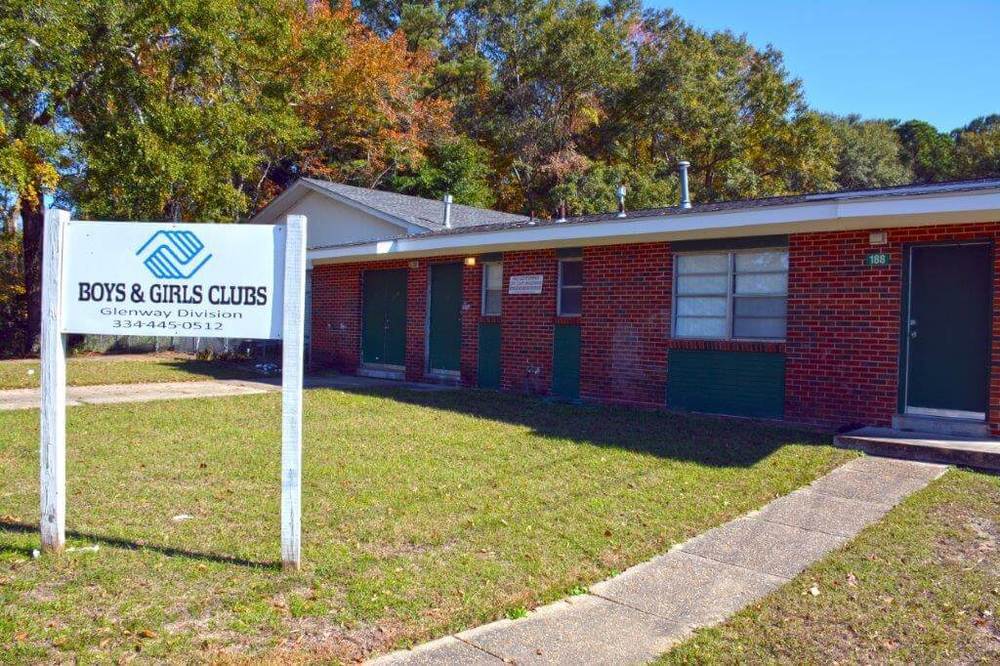 Exterior of a brick building and sign out front that says Boys & Girls Clubs.